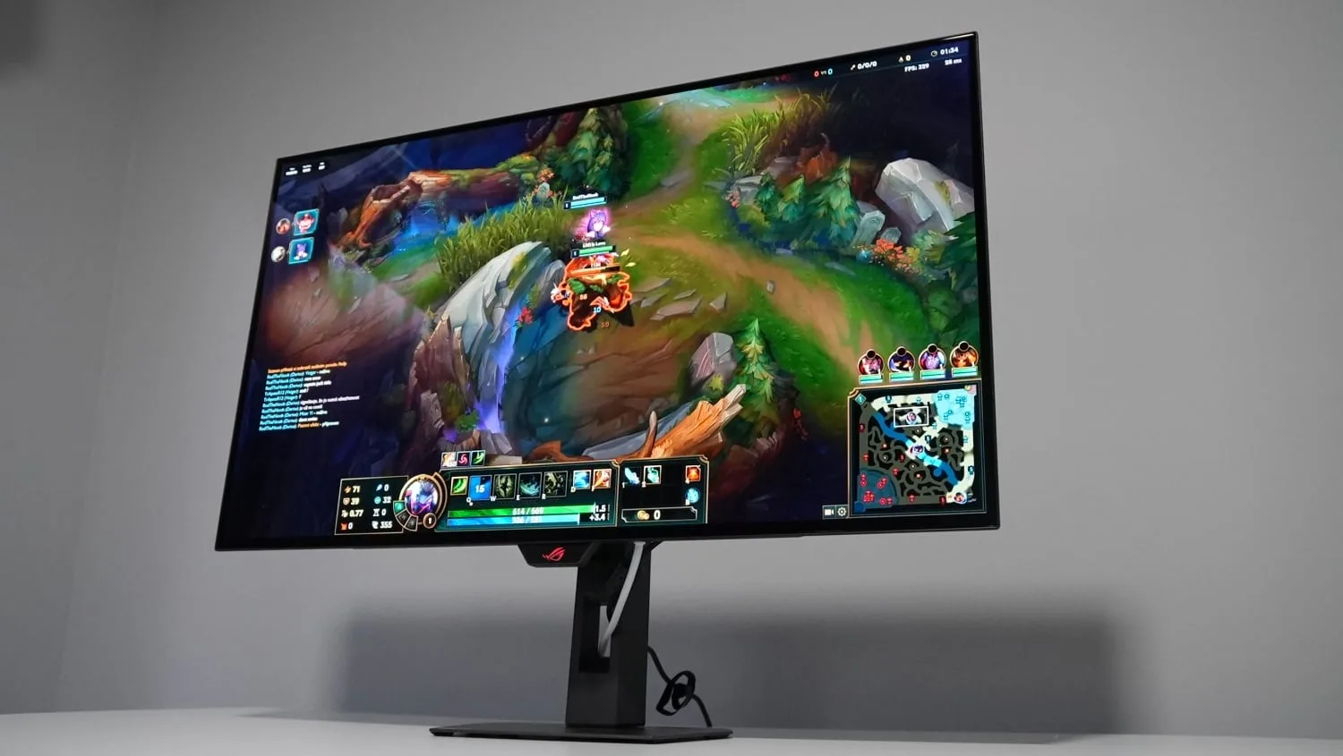Asus ROG Strix XG32UCWMG gaming monitor with slim bezels and RGB lighting on desk